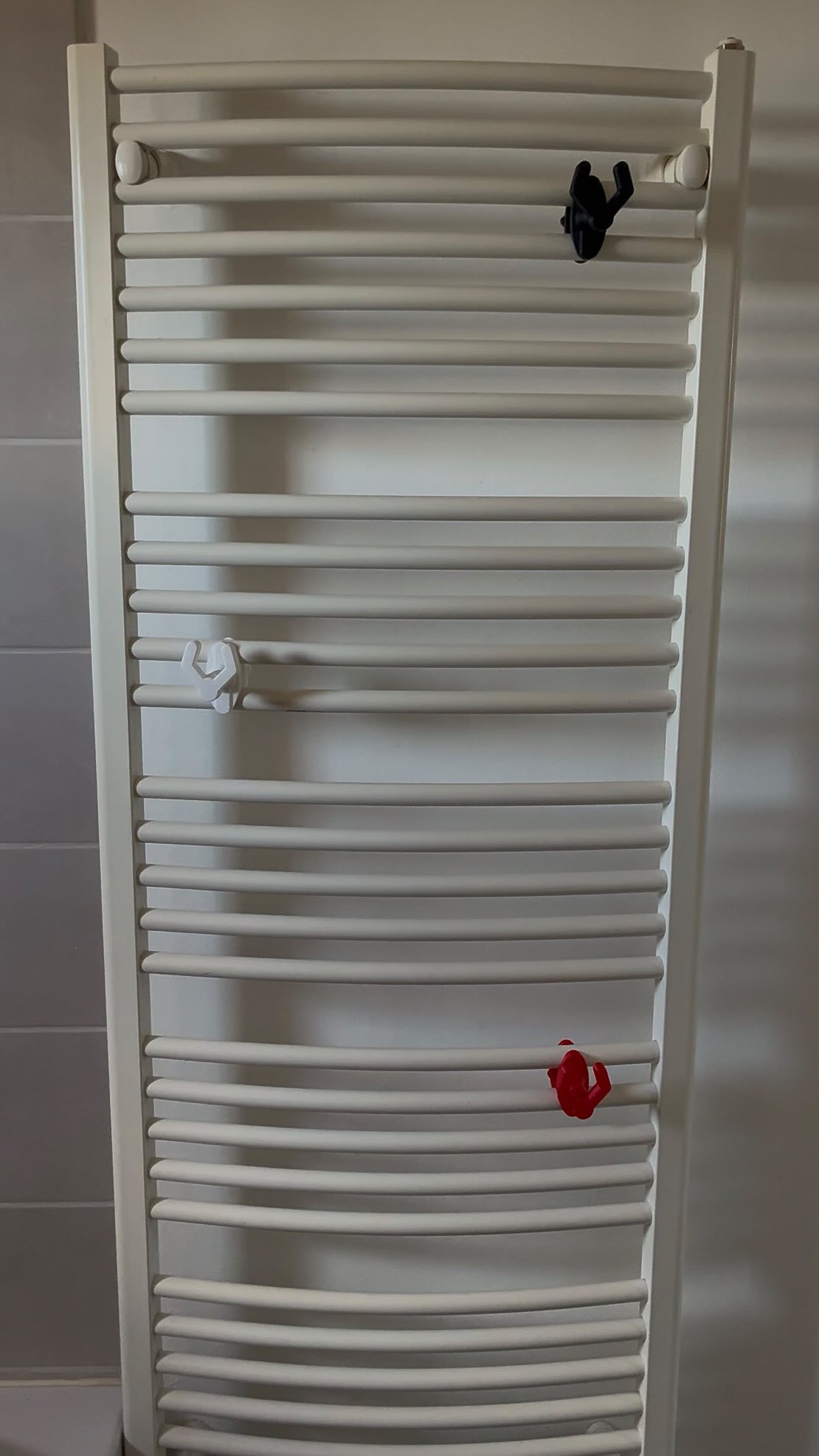My towel kept sliding off the radiator. Now it stays. 

No drilling, no holes, no screws in the wall. Actually no metal...