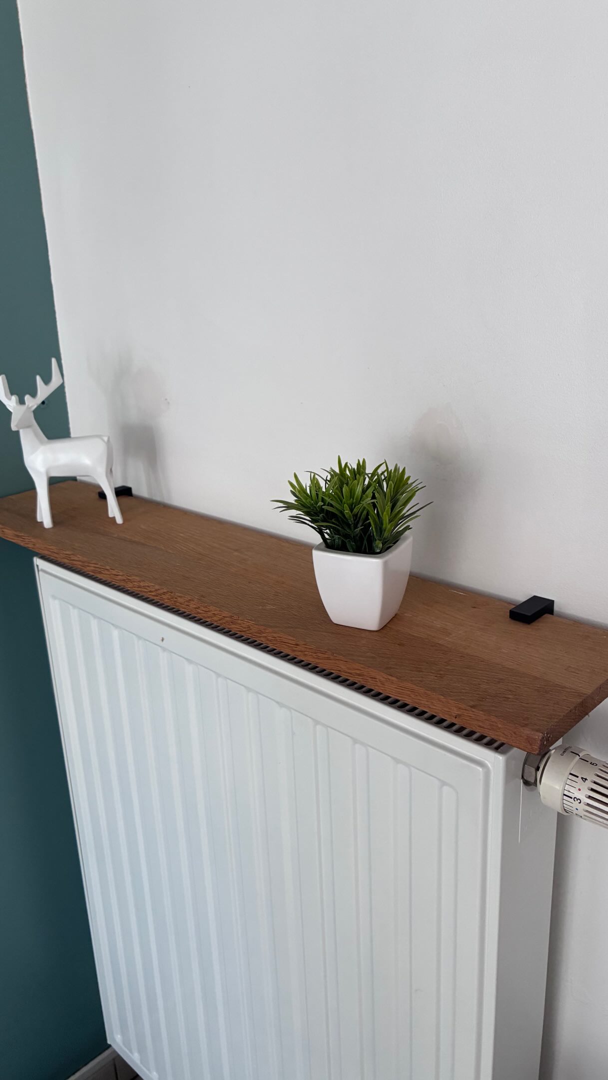 My radiator was just sitting there doing nothing. Now it’s a shelf.

No drilling, no holes, no damage. It just sits on t...